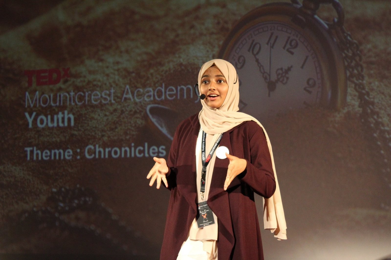 A Mountcrest student speaker on the TEDxMountcrest Academy stage